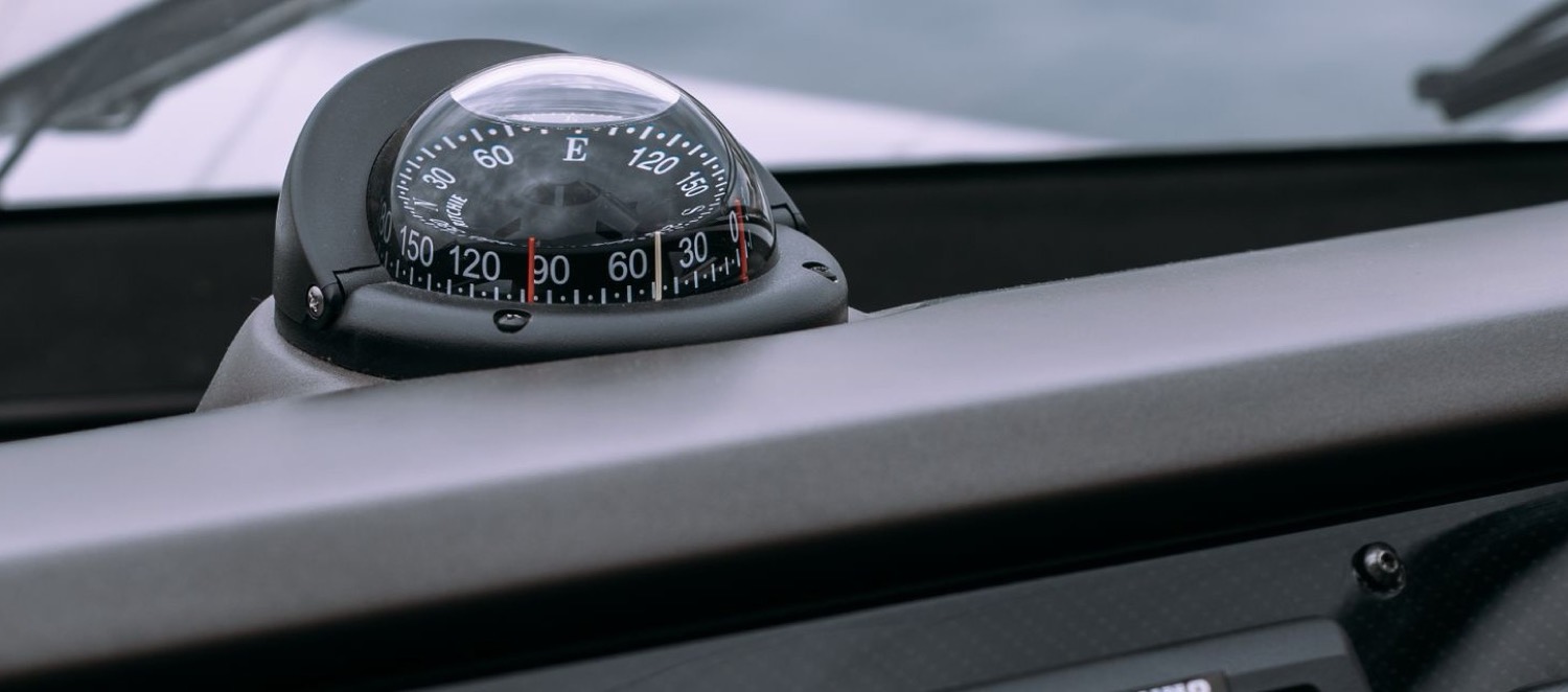 Marine compass dome above a helm instrument panel