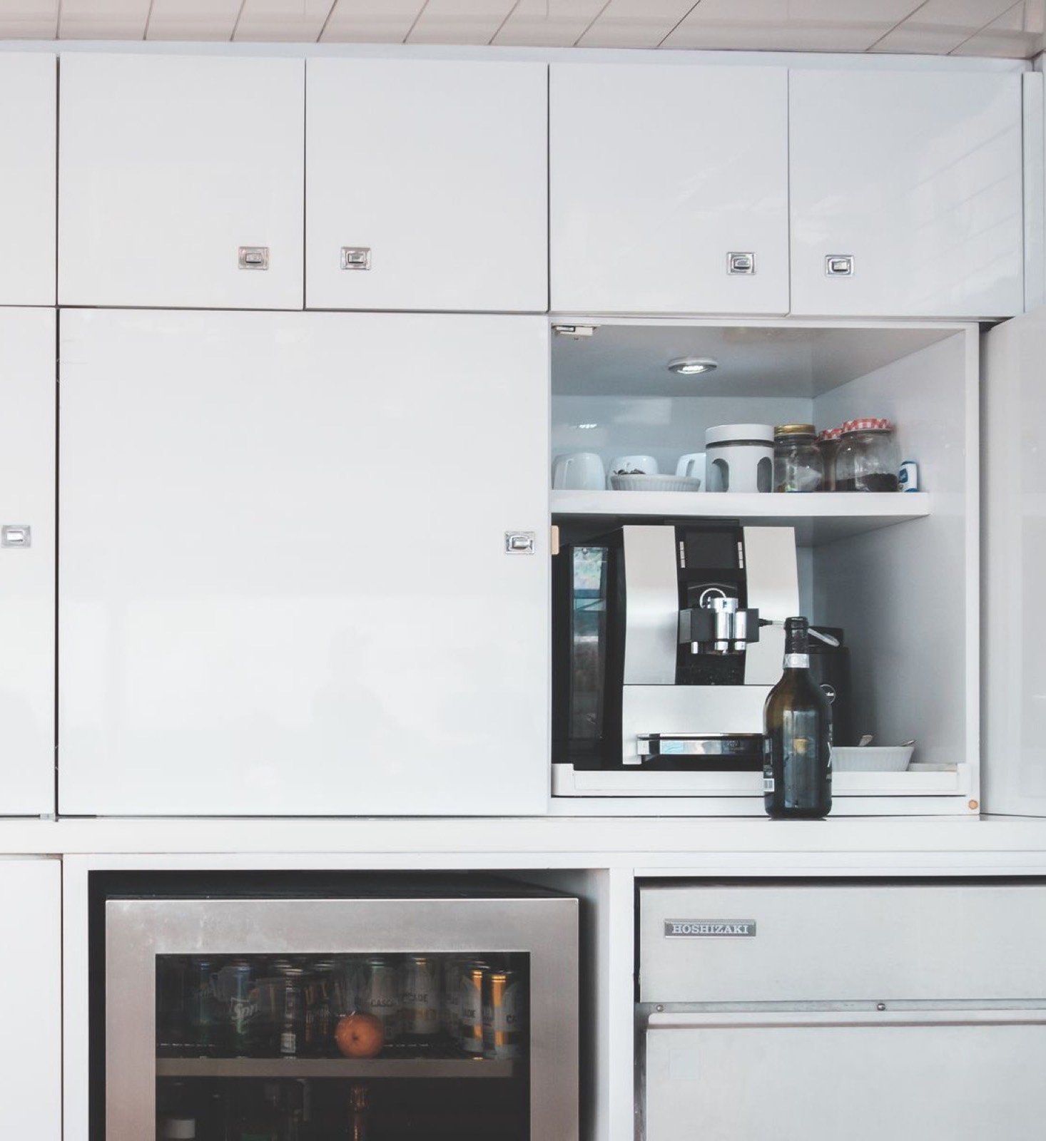 Glass-door beverage refrigerator and ice machine in a yacht galley